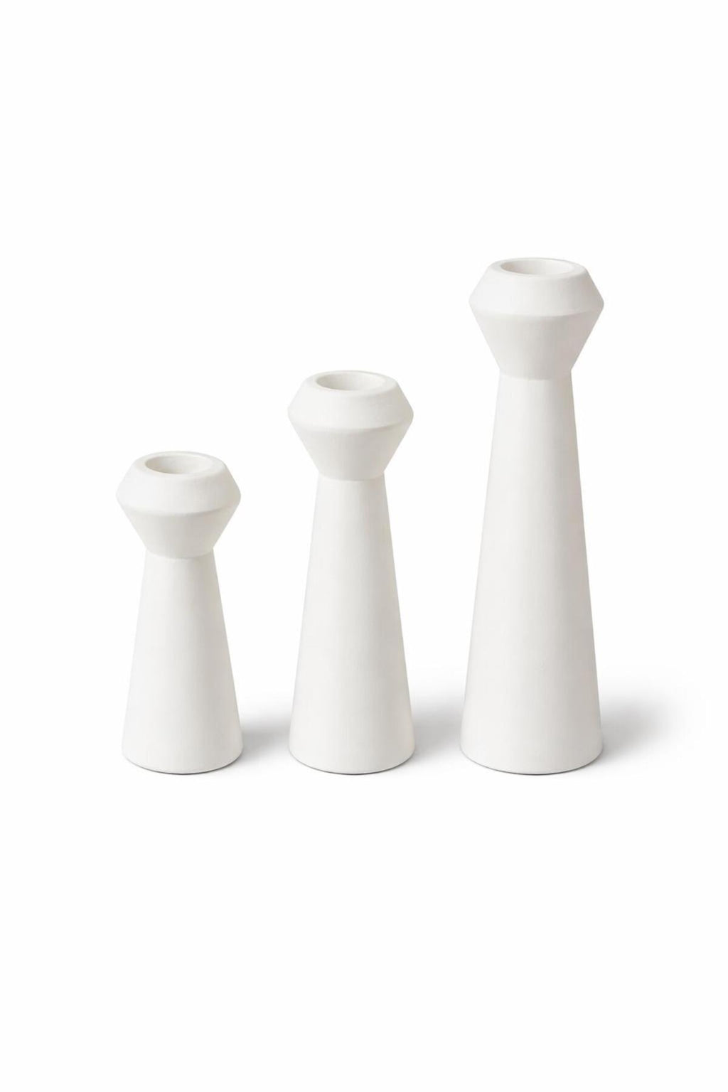 White ceramic candle holders on white