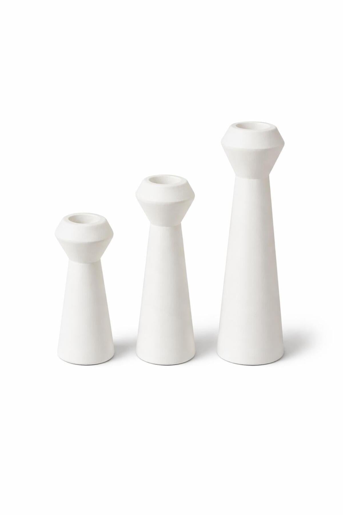 White ceramic candle holders on white