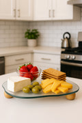 Curved glass tray with wooden ball feet