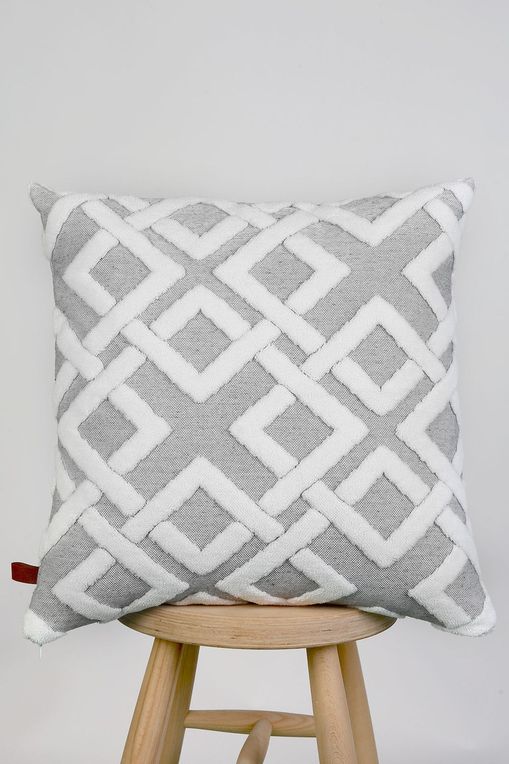 Grey lattice cushion on a stool