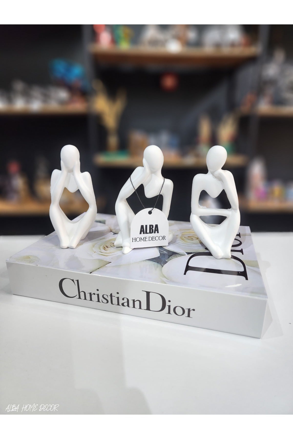 Three thinking men white figurine set