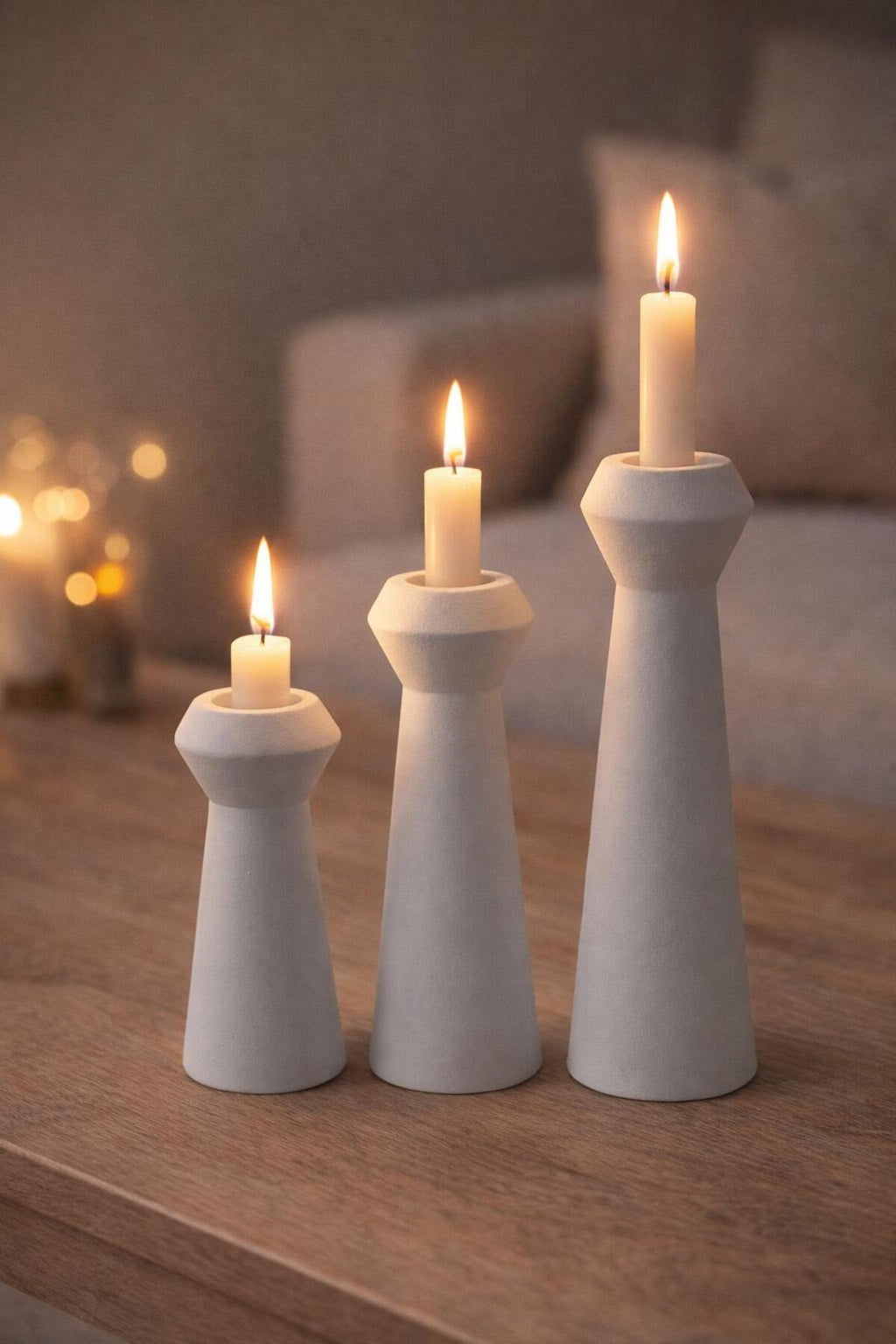 White candle holders with lit candles