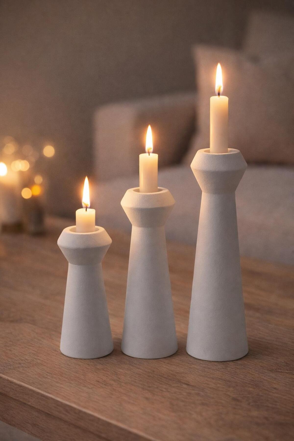 White candle holders with lit candles
