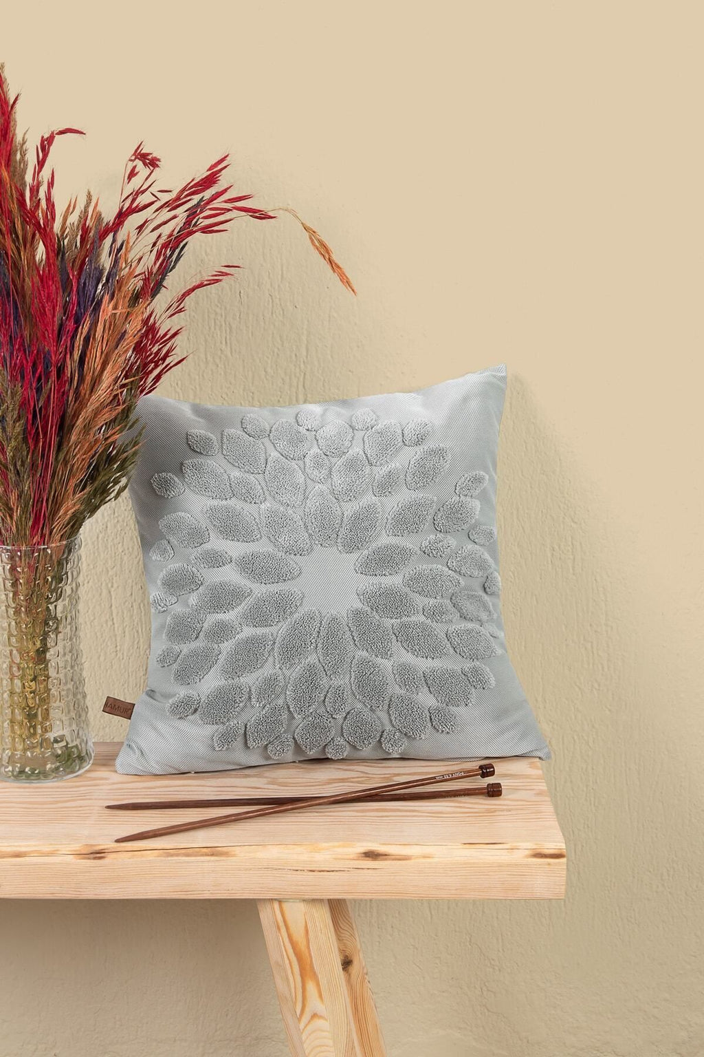 Grey flower cushion on a stool